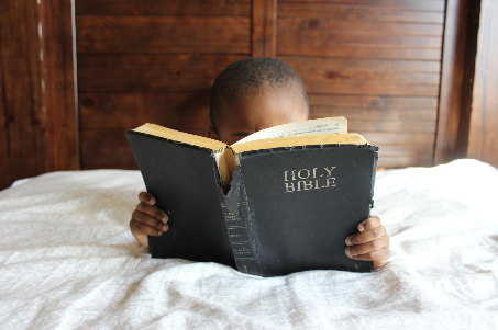 "Boy reading Bible while laying on bed" Photo by Samantha Sophia on Unsplash "Boy reading Bible while laying on bed" Photo by Samantha Sophia on Unsplash