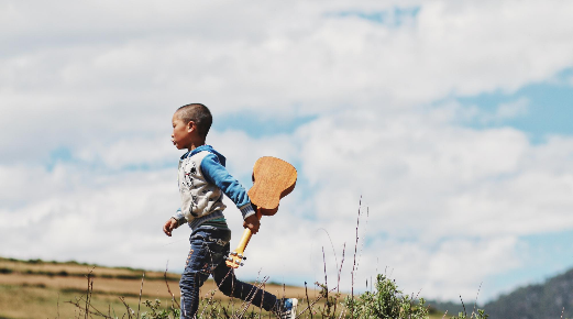 "Boy Running While Holding a Ukulele" by kychan on unsplash "Boy Running While Holding a Ukulele" by kychan on unsplash