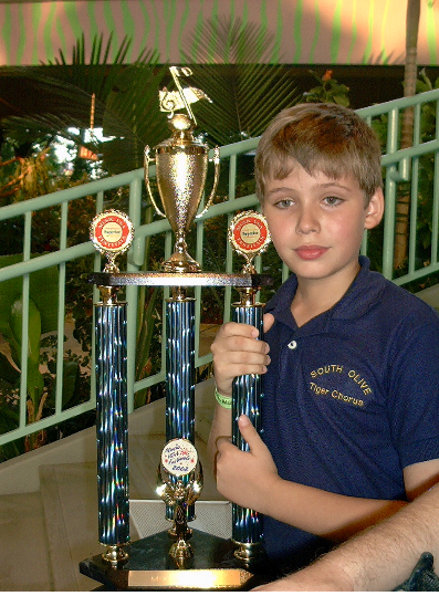 South Olive Elementary Tiger Chorus Member Holding a "Superior" Rating Trophy, InTuneWithYou.com South Olive Elementary Tiger Chorus Member Holding a "Superior" Rating Trophy, InTuneWithYou.com